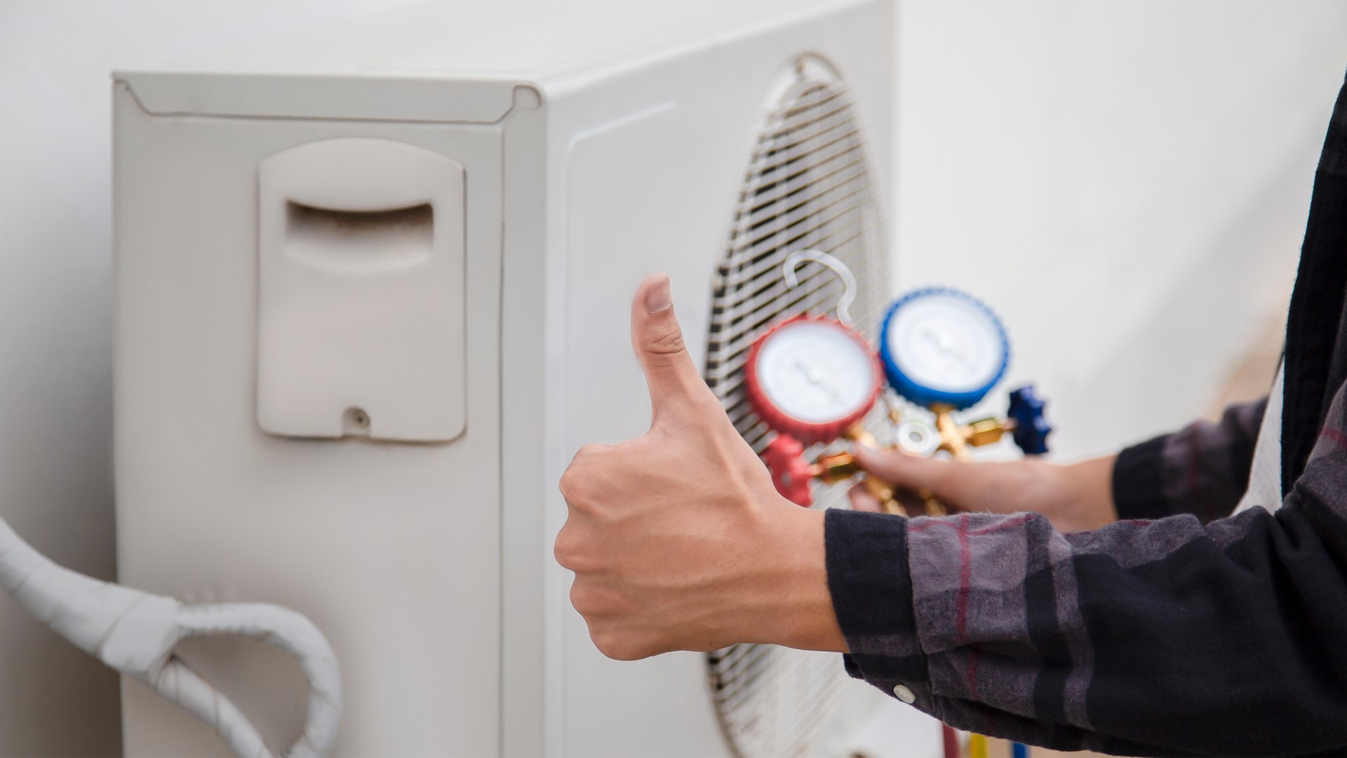 Technician is checking air conditioner ,measuring equipment for filling air conditioners.